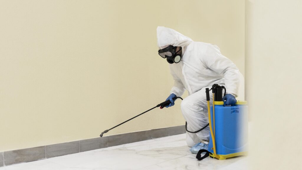 full-shot-man-disinfecting-wall-min